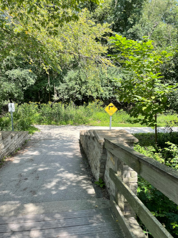 bridge path in woods sign sharp turn